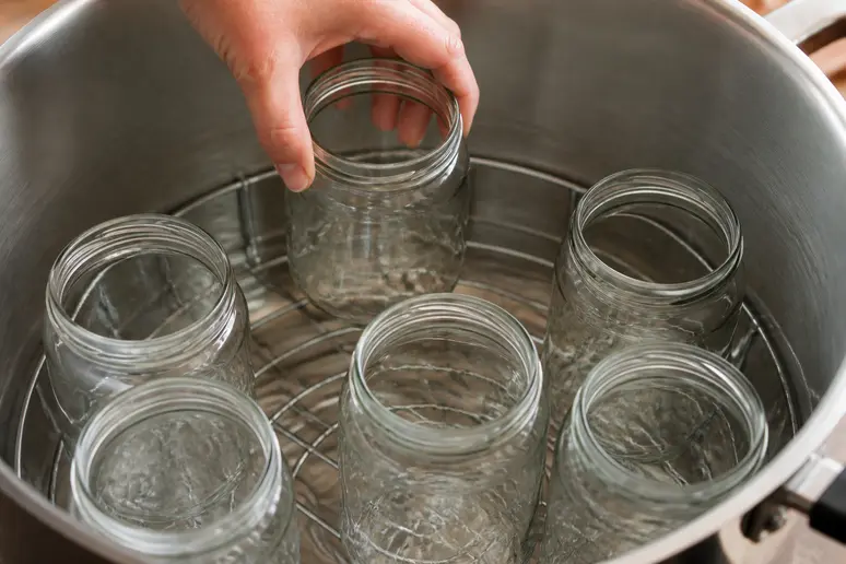 Vorbereitung sterilisierter Einmachgläser zum sicheren Einkochen von Quittenprodukten für die Vorratshaltung.